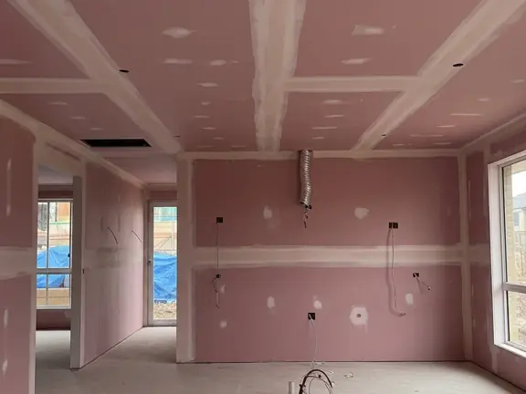 Pink fire rated sheets hung across the ceiling and carried down the separating wall, taped out to the doorway.